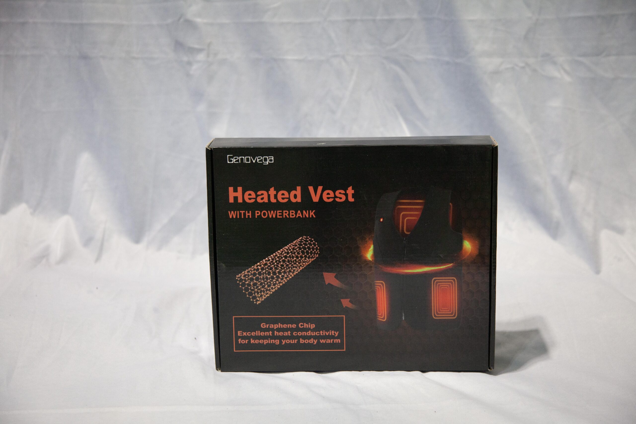Heated vest packaging featuring a graphene chip, highlighting excellent heat conductivity for warmth, includes power bank for convenience.
