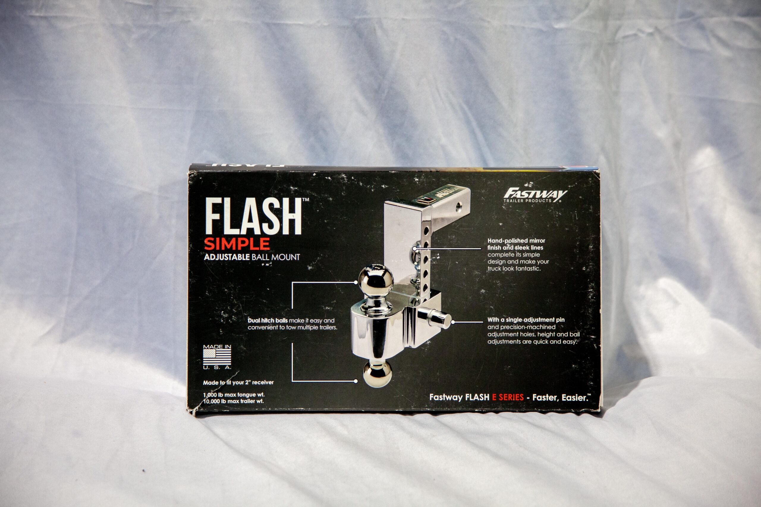 Box of Fastway Flash Simple Adjustable Ball Mount featuring dual hitch balls for towing convenience. Highlights include a hand-polished mirror finish and easy adjustment features. Suitable for 2-inch receivers with a maximum tongue weight of 1,000 lbs and trailer weight of 10,000 lbs. Ideal for users needing versatility in towing multiple trailers.