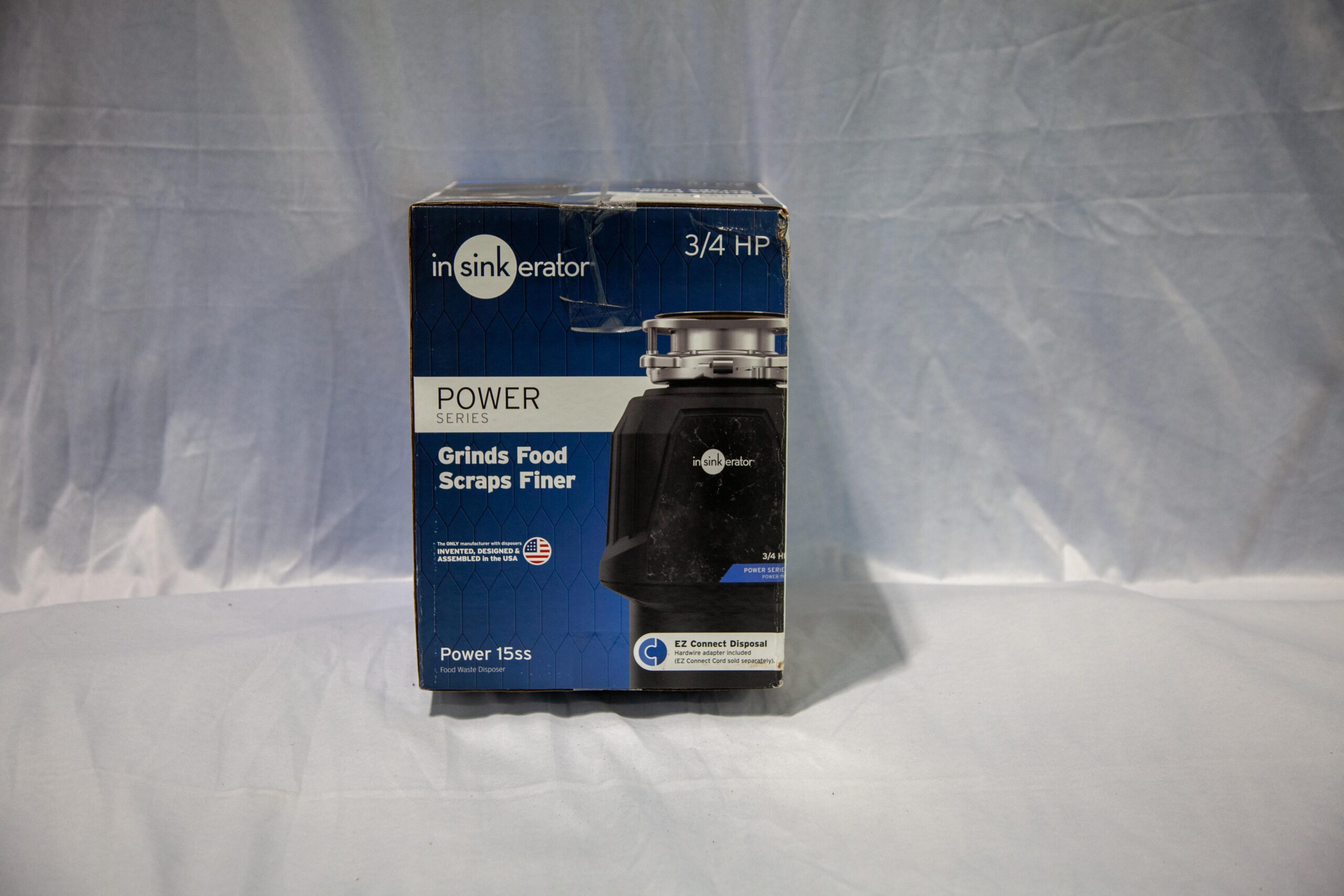 Package of InSinkErator Power Series 3/4 HP food waste disposer featuring Grinds Food Scraps Finer technology. Ideal for efficient kitchen waste management.