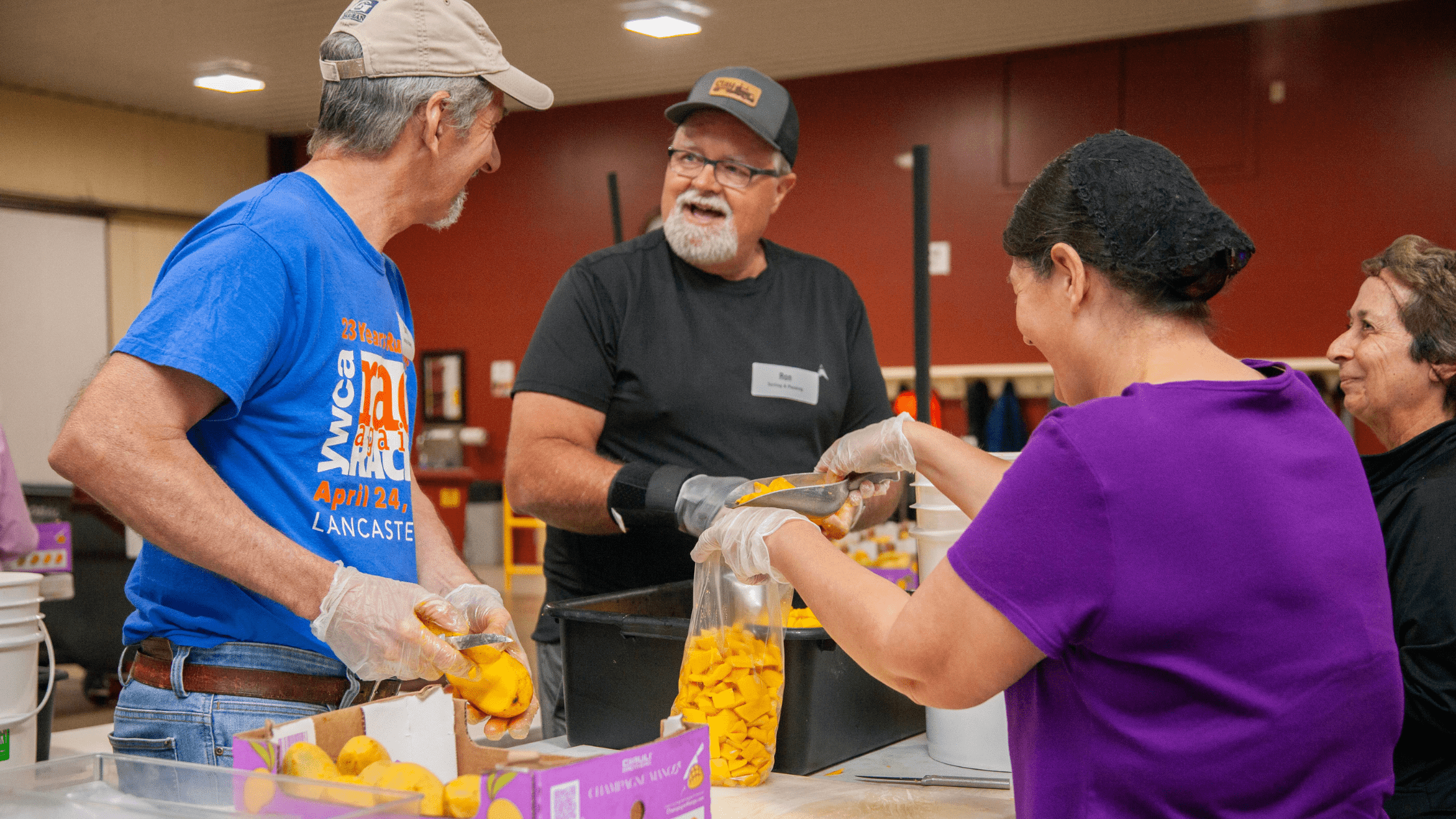 Volunteers packing food items in a community kitchen, engaging in teamwork and collaboration. The scene highlights the importance of community service and food distribution efforts.