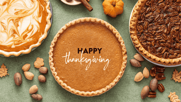Thanksgiving dessert display featuring a pumpkin pie, a pecan pie, and a creamy pumpkin cheesecake, surrounded by assorted nuts and autumn-themed decorations. Text overlay reads "Happy Thanksgiving."