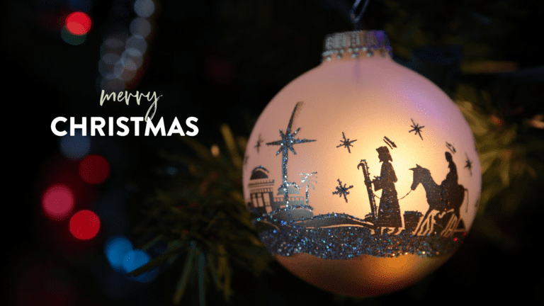 A beautifully illuminated Christmas ornament featuring a silhouette of the Nativity scene, including figures of Mary, Joseph, and a starry background, surrounded by colorful bokeh lights.